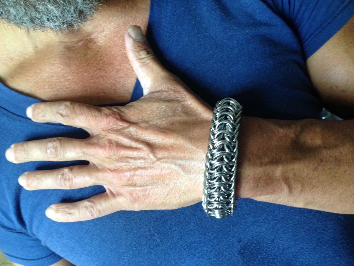 Wide chainmaille bracelet worn on a wrist